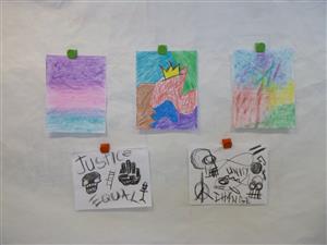 Photo shows a collection of colorful student artwork created in the style of Basquiat.